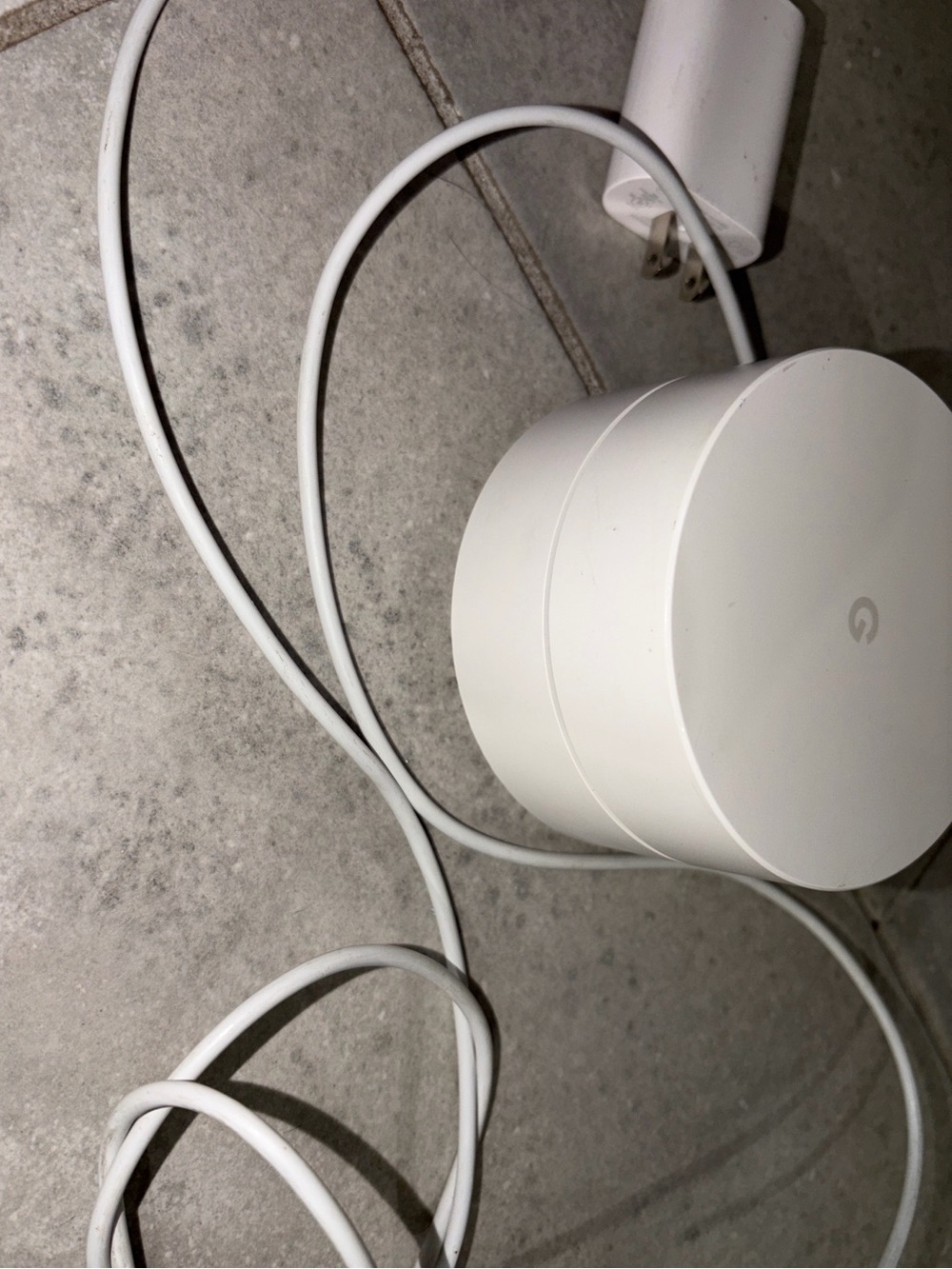 Google mesh Wi‑Fi puck in white with blue LED